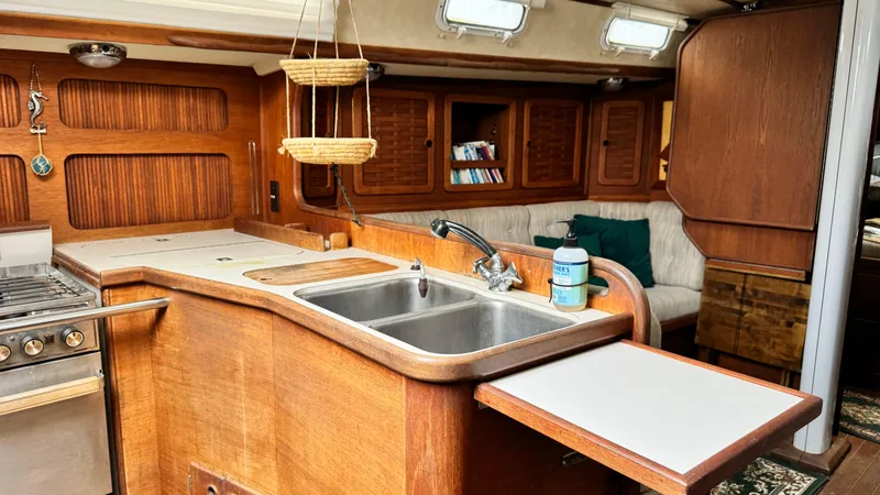 Slide: The Image of Interior of 1990 Sabre 38 sailboat with wooden cabinetry and kitchen area. - 19