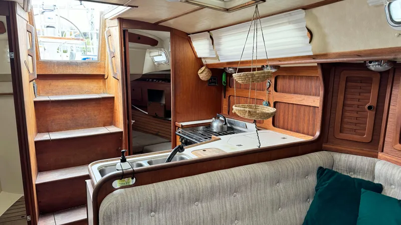 Slide: The Image of Interior of a 1990 Sabre 38 sailboat with wooden cabinetry and cozy seating area. - 22