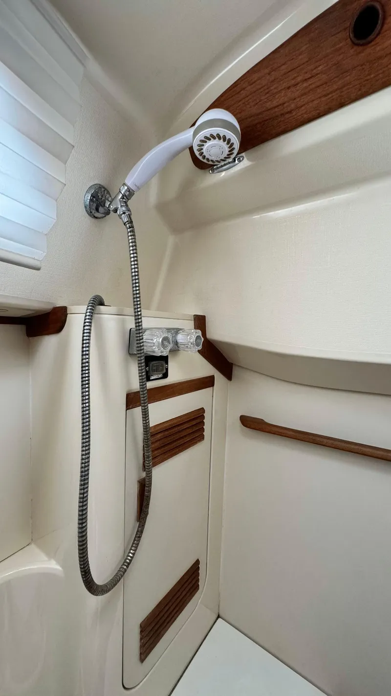 Slide: The Image of 1990 Sabre 38 yacht shower with wood accents and handheld showerhead. - 24