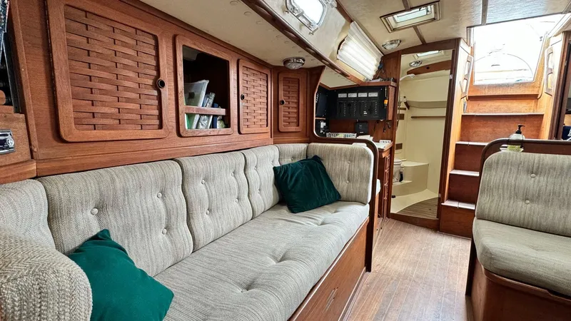 Slide: The Image of Interior of a 1990 Sabre 38 sailboat with cozy seating and wooden cabinetry. - 7