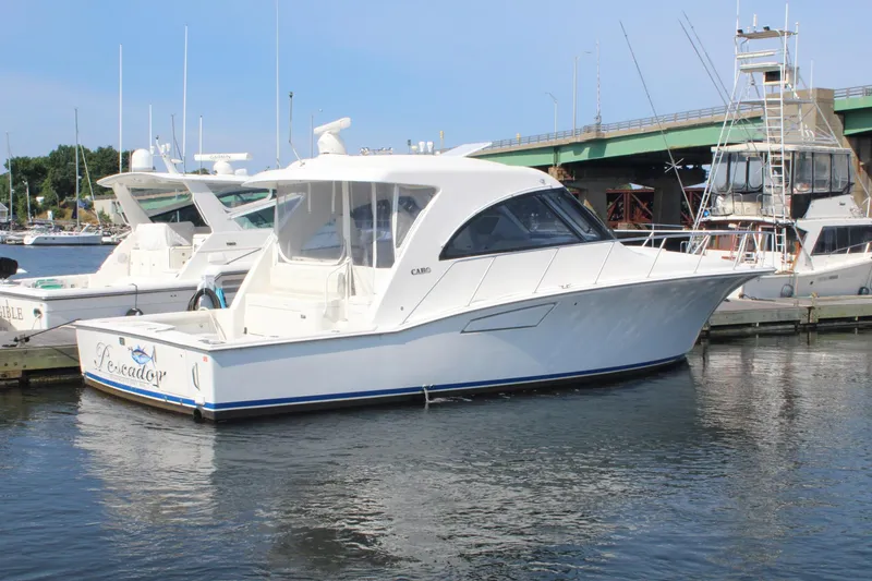 Slide: The Image of 2013 Cabo 40 Hardtop Express yacht docked in marina. - 0