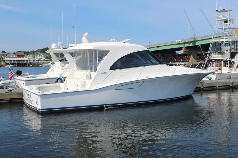 Slide: The Image of 2013 Cabo 40 Hardtop Express yacht docked in marina, side view. - 1
