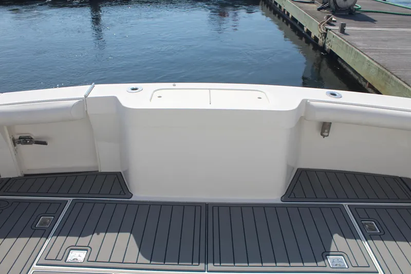 Slide: The Image of 2013 Cabo 40 Hardtop Express boat deck with water and dock in background. - 10