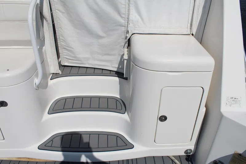 Slide: The Image of 2013 Cabo 40 Hardtop Express boat steps and storage compartment. - 13