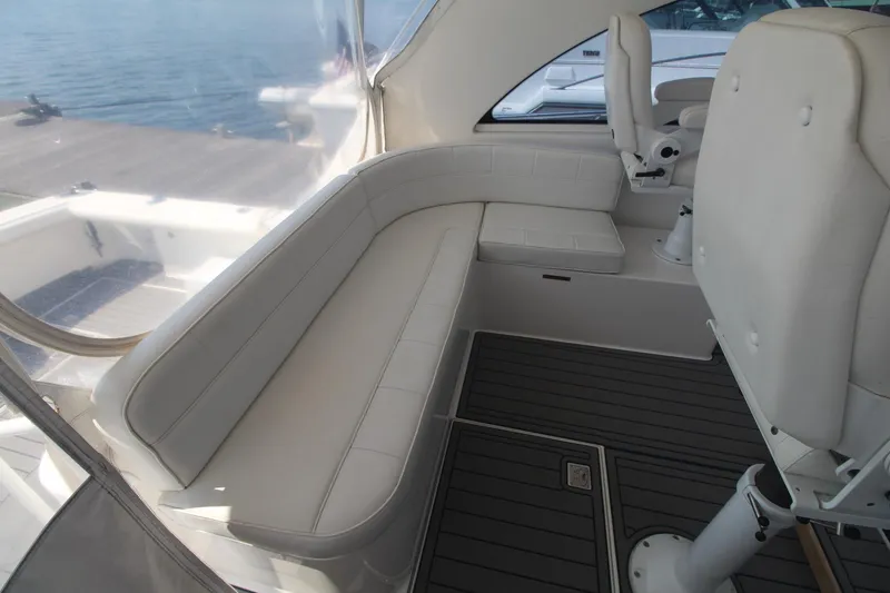 Slide: The Image of 2013 Cabo 40 Hardtop Express interior with white seating and ocean view. - 19