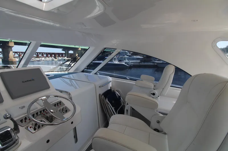 Slide: The Image of Interior of 2013 Cabo 40 Hardtop Express yacht with white seating and navigation equipment. - 21