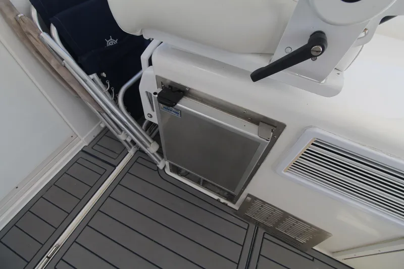 Slide: The Image of Cabo 40 Hardtop Express 2013 boat interior with seating and storage compartment. - 25