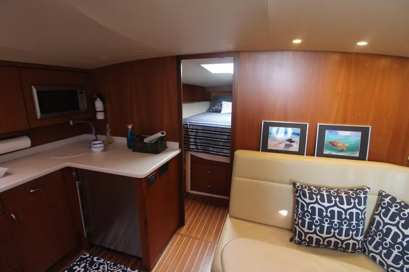 Slide: The Image of Interior of 2013 Cabo 40 Hardtop Express yacht with kitchenette and cozy seating area. - 30