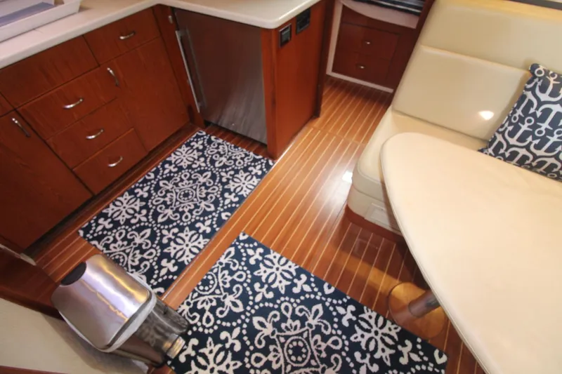 Slide: The Image of Interior of 2013 Cabo 40 Hardtop Express with wood flooring and elegant seating area. - 31