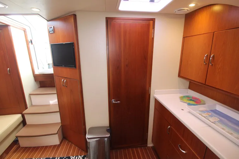 Slide: The Image of Interior of 2013 Cabo 40 Hardtop Express yacht with wood cabinetry and modern amenities. - 32