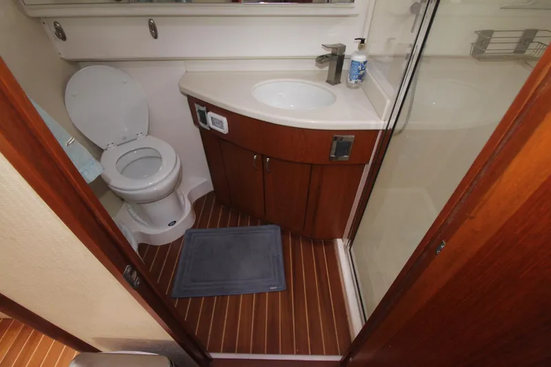 Slide: The Image of 2013 Cabo 40 Hardtop Express bathroom with toilet, sink, and shower. - 35