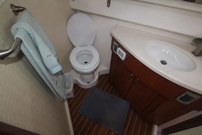Slide: The Image of 2013 Cabo 40 Hardtop Express bathroom with toilet, sink, and towel. - 36
