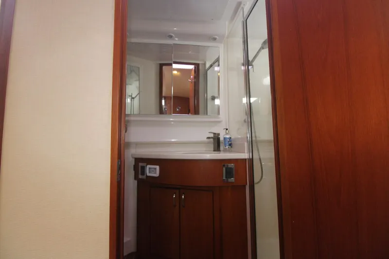 Slide: The Image of 2013 Cabo 40 Hardtop Express bathroom with wooden cabinetry and modern fixtures. - 37