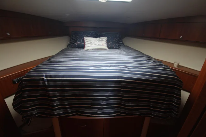 Slide: The Image of Cozy cabin interior of 2013 Cabo 40 Hardtop Express with striped bedding. - 38