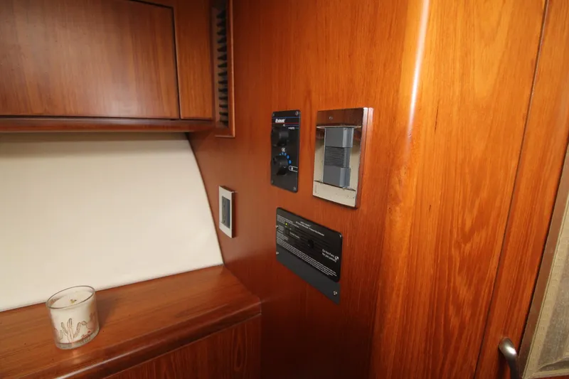 Slide: The Image of Interior of 2013 Cabo 40 Hardtop Express with wooden paneling and control panels. - 41