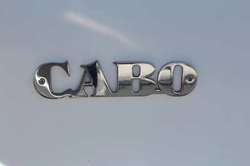 Slide: The Image of Chrome "Cabo" logo on 2013 Cabo 40 Hardtop Express boat. - 6