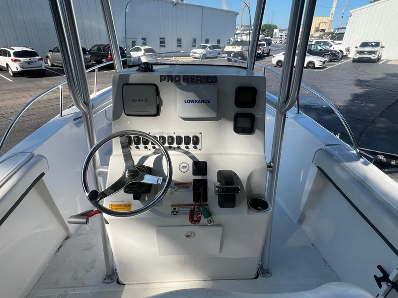 Slide: The Image of 2011 Sea Fox 236CC Pro Series boat console with steering wheel and navigation equipment. - 12