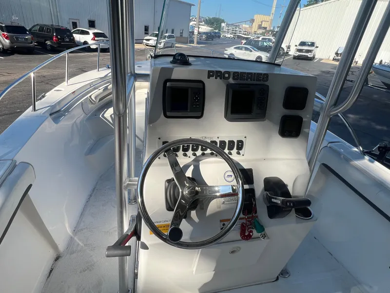 Slide: The Image of 2011 Sea Fox 236CC Pro Series boat console with steering wheel and controls. - 15
