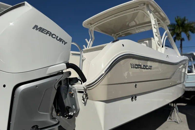 The Image of 2025 World Cat 296 DC boat with Mercury engine, showcased under clear blue sky. - 0