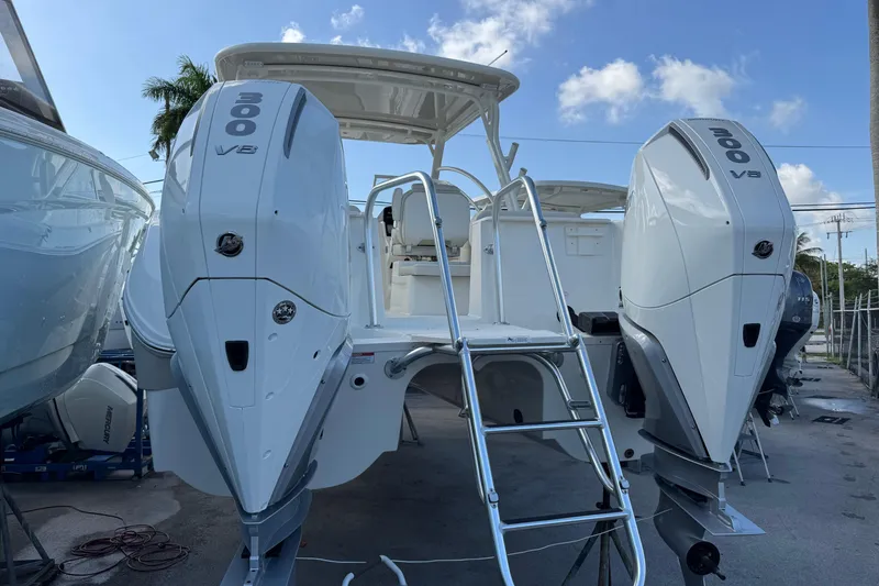 Slide: The Image of 2025 World Cat 296 DC boat with dual 300 V8 engines, docked under a clear sky. - 10