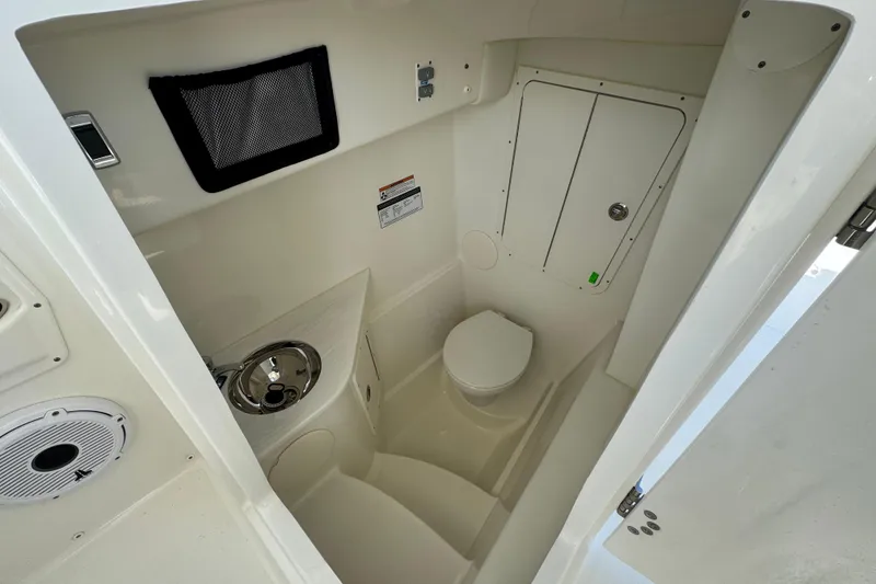 Slide: The Image of 2025 World Cat 296 DC boat interior with compact bathroom and sink. - 8