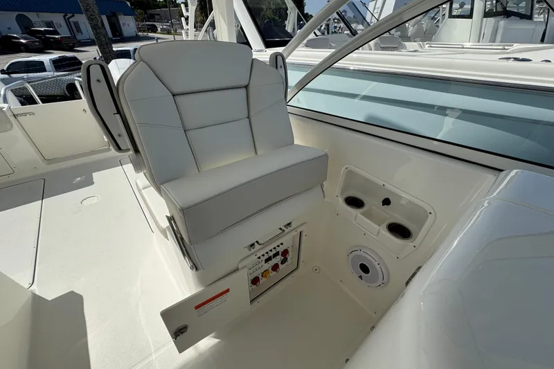 Slide: The Image of 2025 World Cat 296 DC boat interior with white seating and control panel. - 9