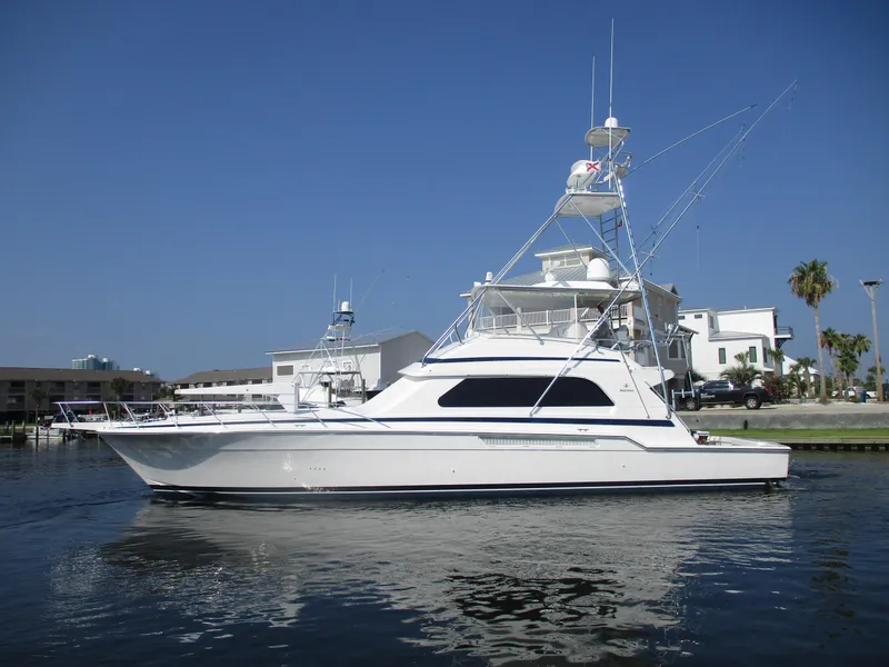 Slide: The Image of Bertram 60 Convertible 2000 yacht on calm water, clear sky background. - 1