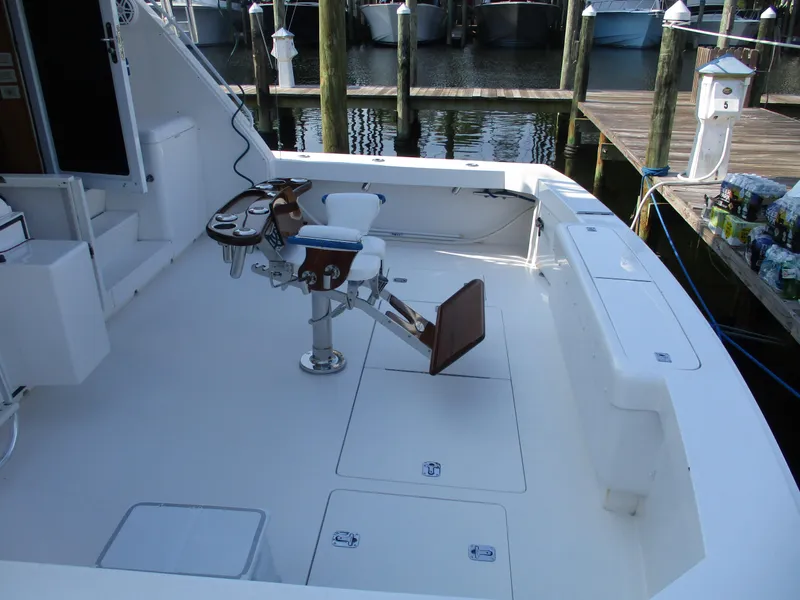 Slide: The Image of Bertram 60 Convertible 2000 yacht deck with fishing chair and rod holders. - 11