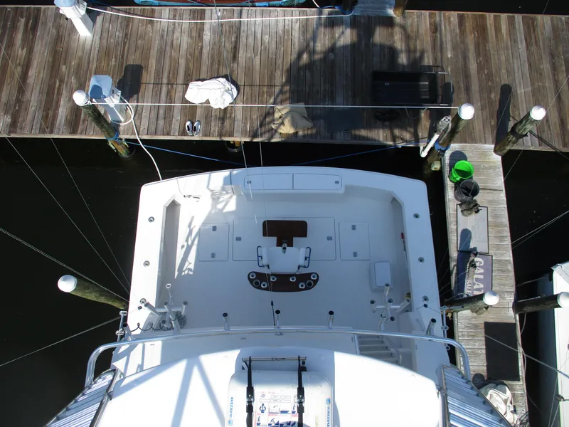 Slide: The Image of Overhead view of a 2000 Bertram 60 Convertible yacht docked at a marina. - 13