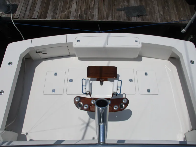 Slide: The Image of Bertram 60 Convertible 2000 boat deck with fishing chair and storage compartments. - 15