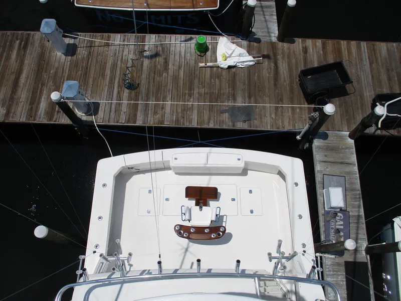 Slide: The Image of Top view of a 2000 Bertram 60 Convertible yacht docked at a marina. - 16