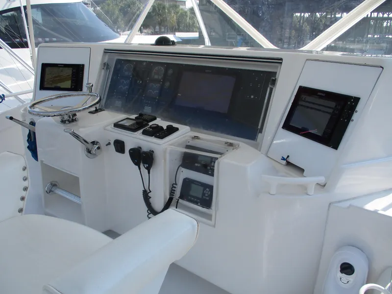 Slide: The Image of Bertram 60 Convertible 2000 yacht helm with advanced navigation controls and displays. - 19
