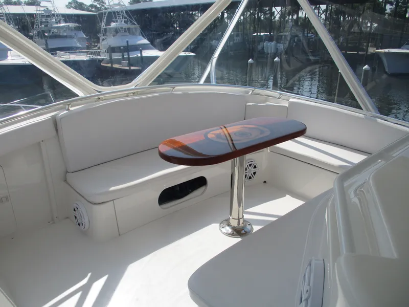 Slide: The Image of Bertram 60 Convertible 2000 yacht interior with white seating and wooden table. - 24