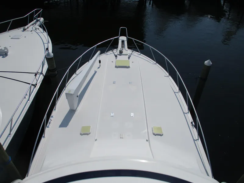 Slide: The Image of Bertram 60 Convertible 2000 yacht deck, docked in calm waters. - 27
