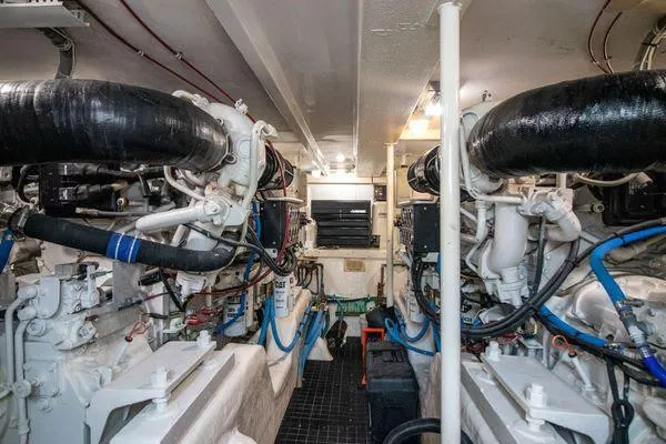 Slide: The Image of Engine room of a 2000 Bertram CNV boat with dual engines and mechanical systems. - 32