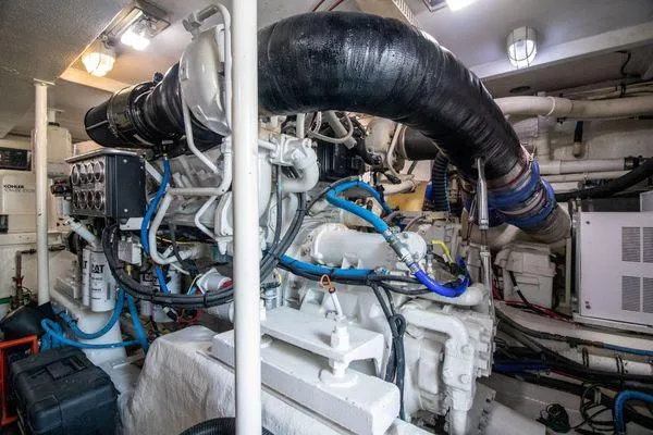 Slide: The Image of Engine room of a 2000 Bertram CNV boat with visible machinery and components. - 34