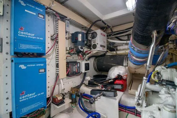 Slide: The Image of Engine room of a 2000 Bertram CNV boat with Victron Energy battery chargers. - 35