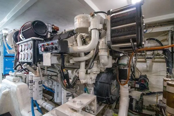 Slide: The Image of Engine room of a 2000 Bertram CNV boat with complex machinery and piping. - 37