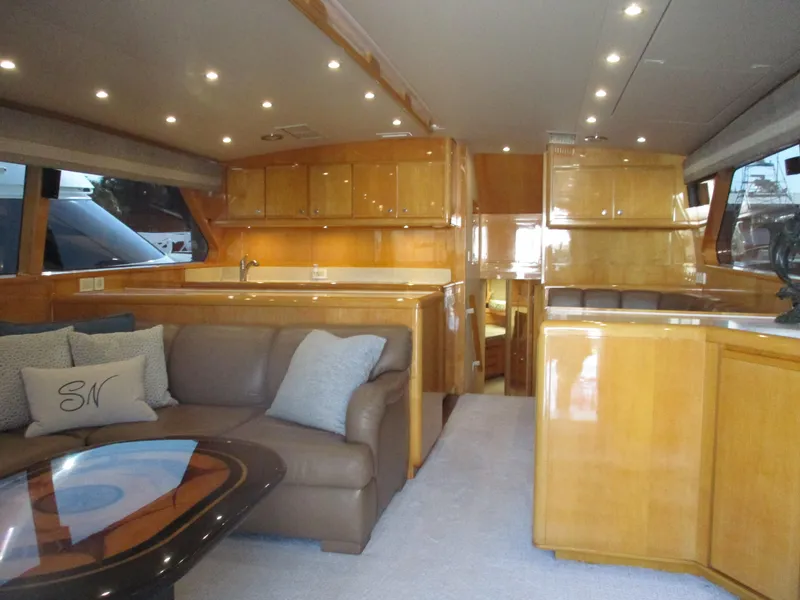 Slide: The Image of Luxurious interior of a 2000 Bertram 60 Convertible yacht with leather seating and wooden cabinetry. - 39
