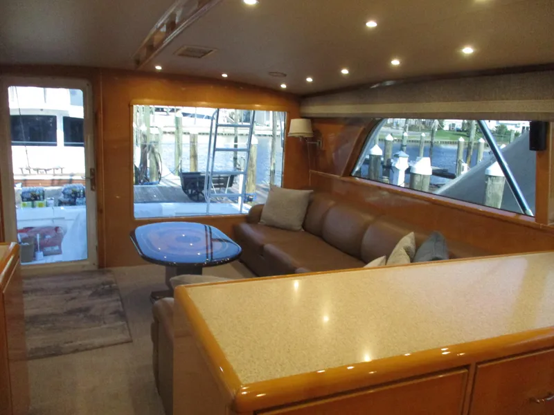 Slide: The Image of Luxurious interior of a 2000 Bertram 60 Convertible yacht with leather seating and large windows. - 40