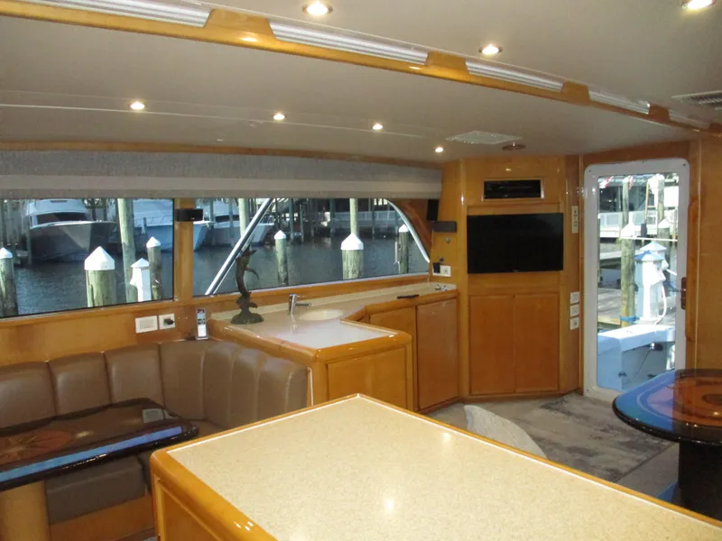 Slide: The Image of Interior of 2000 Bertram 60 Convertible yacht with modern furnishings and large windows. - 41