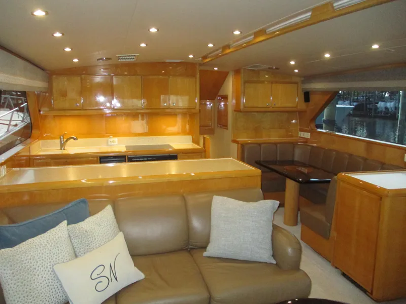 Slide: The Image of Luxurious interior of a 2000 Bertram 60 Convertible yacht with modern kitchen and seating area. - 42