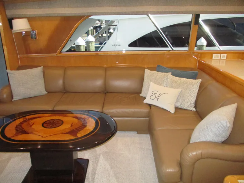Slide: The Image of Luxurious interior of 2000 Bertram 60 Convertible yacht with leather seating and elegant table. - 43