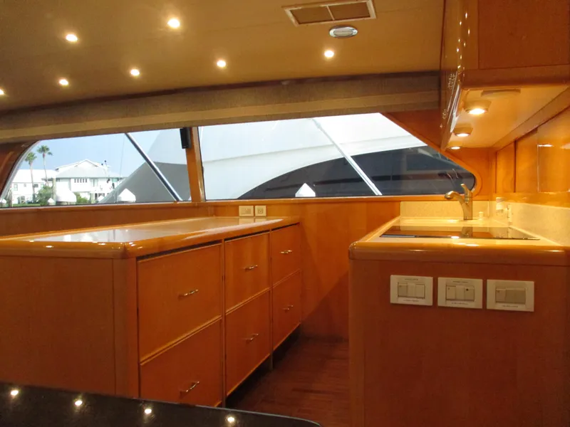 Slide: The Image of Luxurious interior of 2000 Bertram 60 Convertible yacht with wood cabinetry and modern lighting. - 45