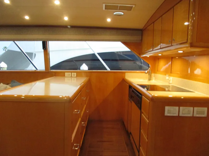 Slide: The Image of Luxurious kitchen interior of 2000 Bertram 60 Convertible yacht with wood cabinetry. - 46