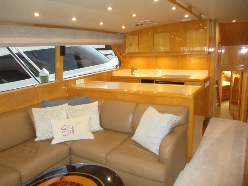 Slide: The Image of Luxurious interior of 2000 Bertram 60 Convertible yacht with leather seating and modern kitchen. - 48