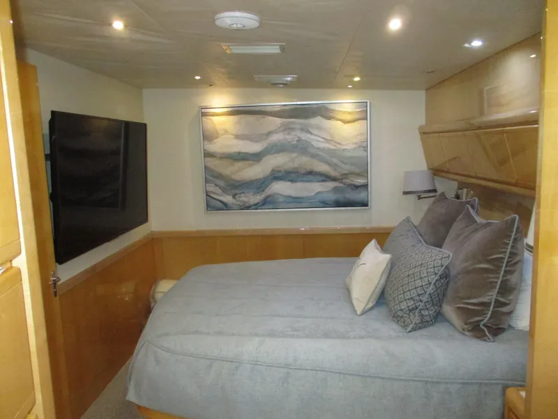 Slide: The Image of Luxurious bedroom interior of 2000 Bertram 60 Convertible yacht with modern decor. - 49