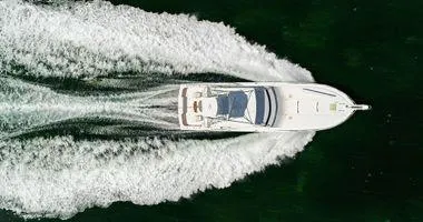 Slide: The Image of Aerial view of a 2000 Bertram CNV boat cruising on water. - 6