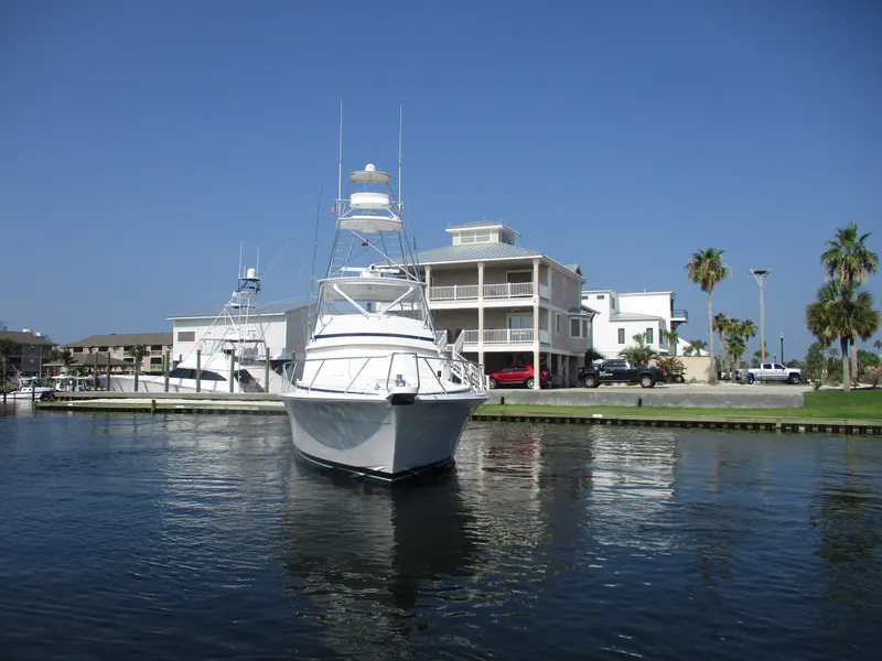 Slide: The Image of Bertram 60 Convertible yacht docked near waterfront homes, 2000 model. - 9