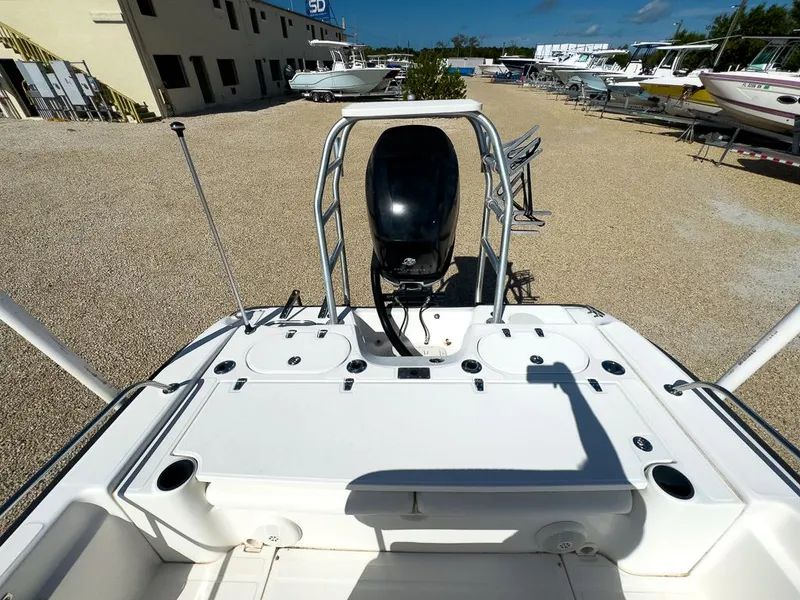Slide: The Image of 2007 Boston Whaler 220 Dauntless boat stern view with outboard motor in a boatyard. - 11